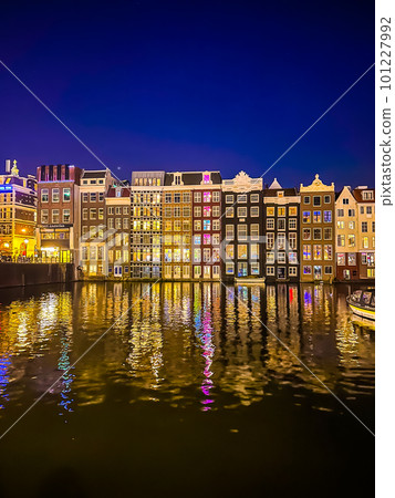 Damrak narrow houses at night in Amsterdam center, Netherlands Damrak narrow houses at night in Amsterdam center, Netherlands 101227992