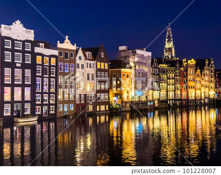 Damrak narrow houses at night in Amsterdam center, Netherlands Damrak narrow houses at night in Amsterdam center, Netherlands 101228007