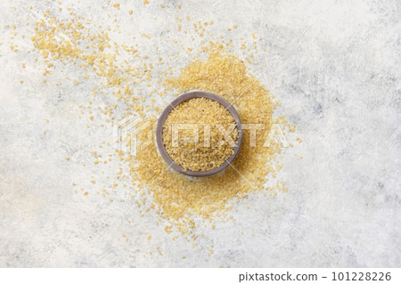 Wooden bowl with Dry uncooked bulgur wheat grain top view. Healthy food Wooden bowl with Dry uncooked bulgur wheat grain top view. Healthy food 101228226