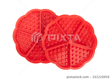 Two red silicone molds for baking waffles isolated on a white background. Two red silicone molds for baking waffles isolated on a white background. 101228958