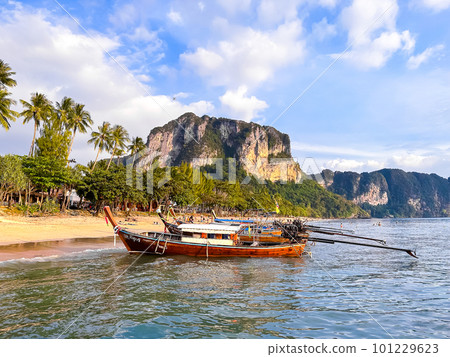 Long tail boats at sunset in Railay beach in Krabi, Thailand Long tail boats at sunset in Railay beach in Krabi, Thailand 101229623