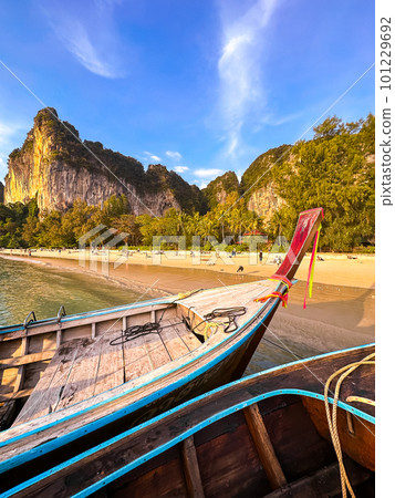 Long tail boats at sunset in Railay beach in Krabi, Thailand Long tail boats at sunset in Railay beach in Krabi, Thailand 101229692