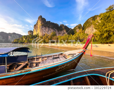Long tail boats at sunset in Railay beach in Krabi, Thailand Long tail boats at sunset in Railay beach in Krabi, Thailand 101229724