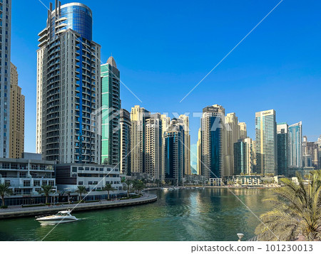 Dubai Marina, harbour, cruise boat and canal promenade view at sunset, in Dubai, United Arab Dubai Marina, harbour, cruise boat and canal promenade view at sunset, in Dubai, United Arab 101230013