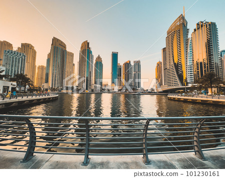 Dubai Marina, harbour, cruise boat and canal promenade view at sunset, in Dubai, United Arab Dubai Marina, harbour, cruise boat and canal promenade view at sunset, in Dubai, United Arab 101230161