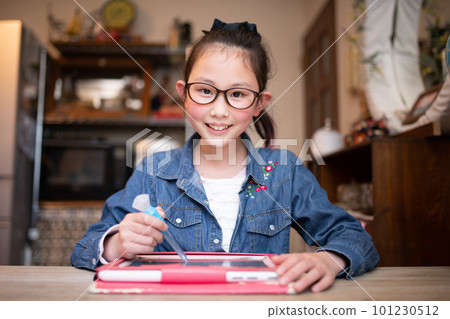 girl with glasses learning on tablet girl with glasses learning on tablet 101230512