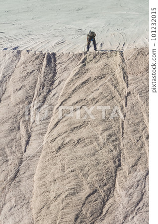 Worker shoveling bulk salt, Salinas Grandes de Hidalgo, La Pampa, Argentina. Worker shoveling bulk salt, Salinas Grandes de Hidalgo, La Pampa, Argentina. 101232015