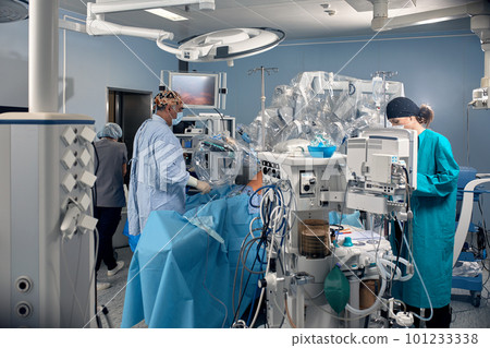 Surgical system with minimally invasive robot in a hospital. Robotic technological equipment, manipulator surgeon in a futuristic operating room. Medical innovation 3D endoscopy for robotic surgery in Surgical system with minimally invasive robot in a hospital. Robotic technological equipment, manipulator surgeon in a futuristic operating room. Medical innovation 3D endoscopy for robotic surgery in 101233338