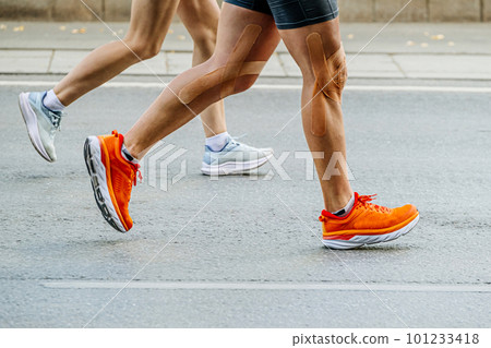 legs man and woman run together city marathon race 101233418