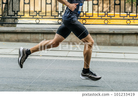 male runner in black tights running city marathon male runner in black tights running city marathon 101233419
