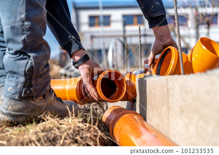installation of a sewage plastic pipe during the construction of a house 101233535