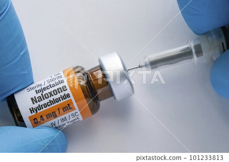 Calgary, Alberta, Canada. Mar 25, 2023.A person using a Naloxone vial with a syringe stock photo Calgary, Alberta, Canada. Mar 25, 2023.A person using a Naloxone vial with a syringe stock photo 101233813