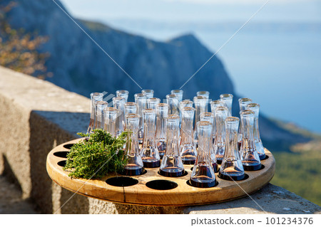 Wooden plate with strong sweet Croatian aperitif fruity drinks like slivovitz, kruskovac and rakija being served outside in de summer in the south of Dalmatia. Typical traditional Croatian liquors 101234376