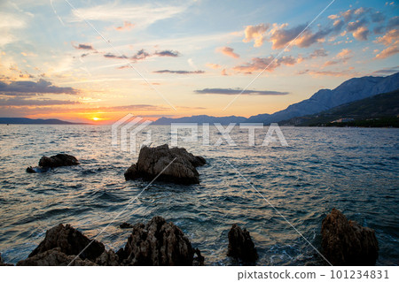 Amazing beach sunset with endless horizon and incredible foamy waves. 101234831