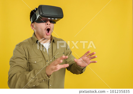 Surprised chinese man with Virtual Reality goggles Surprised chinese man with Virtual Reality goggles 101235835