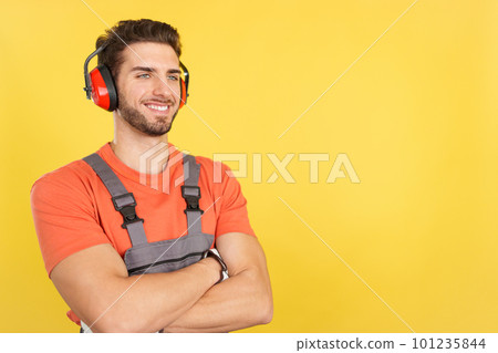 Distracted carpenter looking away with arms crossed Distracted carpenter looking away with arms crossed 101235844