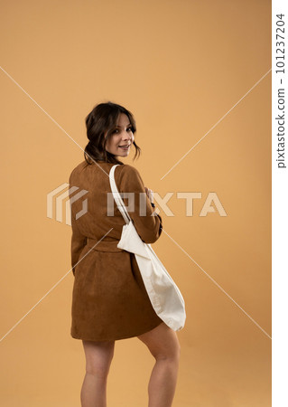 Young woman holding white cotton bag in her hands. Zero waste concept. Mockup. Eco friendly lifestyle. 101237204