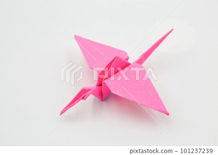 Hand picked pink paper crane origami closeup Hand picked pink paper crane origami closeup 101237239