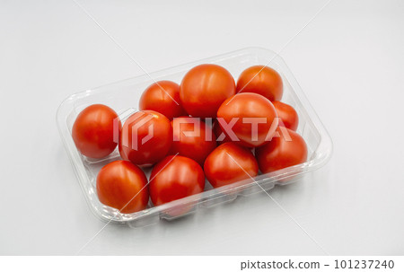 Small cherry tasty fresh red tomatoes closeup on white 101237240