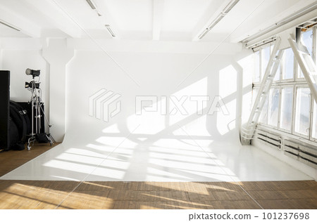 Large sunny photo studio with cyclorama and large panoramic windows. 101237698