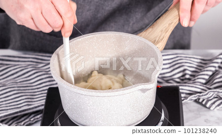 Step by step. Preparing tangzhong in a small saucepan to bake homemade bread. 101238240