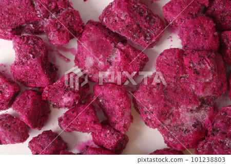 frosted pieces of red dragon fruit closeup photo on white background 101238803