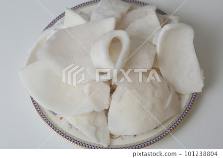 frosted coconut pulp pieces closeup photo on white background 101238804