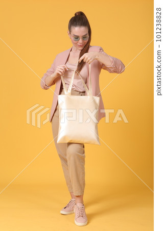 faux leather white shopper bag close up photo with model hand and face 101238828