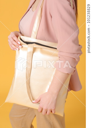 faux leather white shopper bag close up photo with model hand and face 101238829