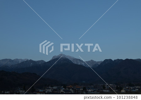 Mt. Kaikomagatake standing in the blue hour in Hakushu-cho, Hokuto City and the townscape of Rokuhakushu 101238848