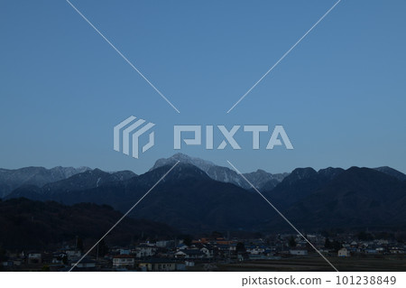 Mt. Kaikomagatake standing in the blue hour in Hakushu-cho, Hokuto City and the townscape of Rokuhakushu 101238849