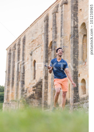 Indian model, mature man dancing Bollywood with smartphone music. Europe travel rhythm on casual. 101238965