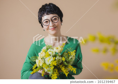 Middle woman with a bouquet of mimosa Middle woman with a bouquet of mimosa 101239467