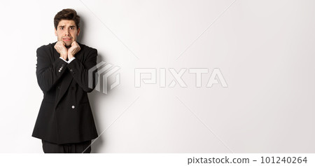 Image of scared and insecure young businessman in suit, trembling from fear and looking horrified, standing over white background Image of scared and insecure young businessman in suit, trembling from fear and looking horrified, standing over white background 101240264