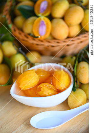 Sweet dessert marian plum fruit  on bowl for food and wooden background, tropical fruit Name in Thailand sweet Yellow Marian Plum Maprang Plango or Mayong chid 101240382