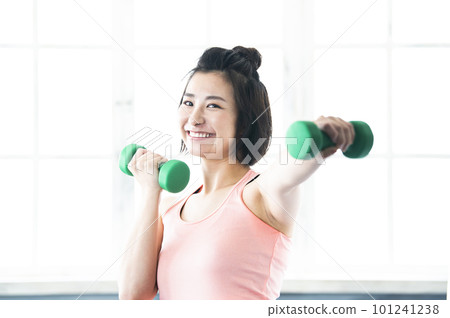 smiling woman with dumbbells smiling woman with dumbbells 101241238