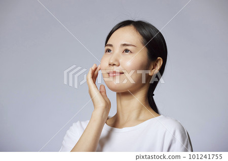 Upper body portrait of a young Japanese woman showing her skin Upper body portrait of a young Japanese woman showing her skin 101241755