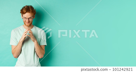 Devious redhead man in glasses and t-shirt pitching an idea, steeple fingers and look from under forehead with sly and smug smile, standing over mint background Devious redhead man in glasses and t-shirt pitching an idea, steeple fingers and look from under forehead with sly and smug smile, standing over mint background 101242921