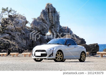 Copen parked on the beach with window rocks 101243079
