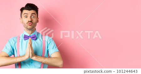 Young guy with cute face pucker lips and asking please, begging for favour, need something and lookin gpleading at camera, standing over pink background Young guy with cute face pucker lips and asking please, begging for favour, need something and lookin gpleading at camera, standing over pink background 101244643