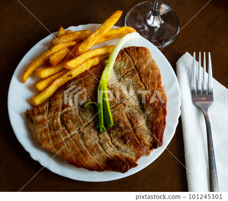 Roasted pork with spring onion and fried potatoes served beautifully on plate Roasted pork with spring onion and fried potatoes served beautifully on plate 101245301