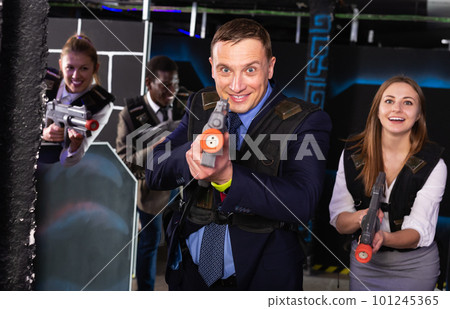 Businessman playing laser tag Businessman playing laser tag 101245365