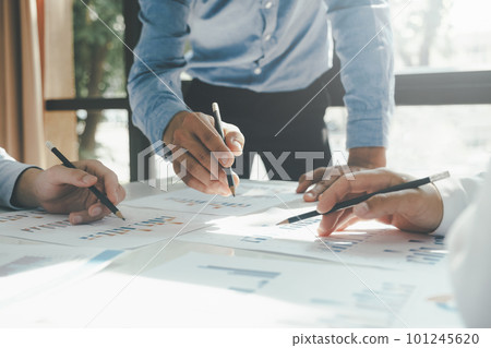 Businessmen working together at desk. 101245620