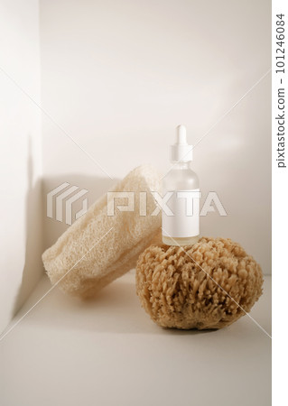 Serum and natural sponges on a light background. Serum and natural sponges on a light background. 101246084