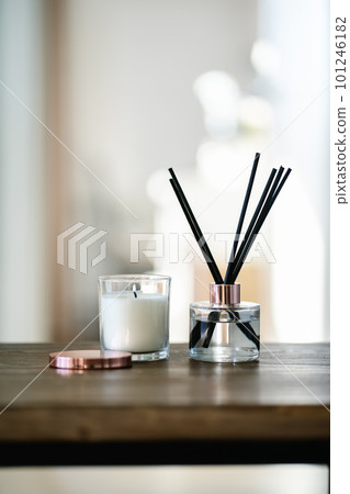 An aromatic reed diffuser stands on a table against a blurry background. An aromatic reed diffuser stands on a table against a blurry background. 101246182