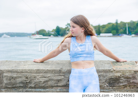 Profile of a smiling Australian girl wearing sportswear on the beach Profile of a smiling Australian girl wearing sportswear on the beach 101246963