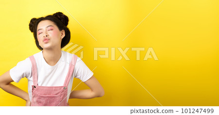 Romantic korean girl close eyes and pucker lips, waiting for sweet kiss on Valentines day, kissing lover, standing on yellow background Romantic korean girl close eyes and pucker lips, waiting for sweet kiss on Valentines day, kissing lover, standing on yellow background 101247499