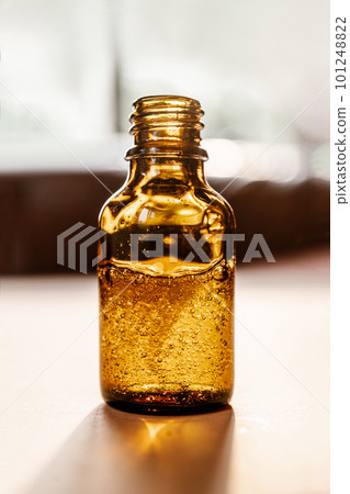 Pipette with cosmetic oil in a brown bottle with bubbles Pipette with cosmetic oil in a brown bottle with bubbles 101248822