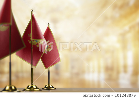 Small flags of the Montenegro on an abstract blurry background 101248879