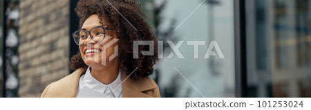 Afro american woman freelancer working remotely while sitting on cafe terrace and looking at side 101253024